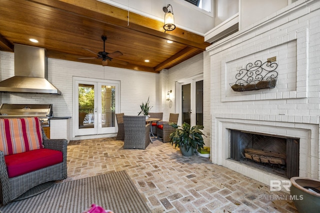 view of patio / terrace featuring a ceiling fan, french doors, area for grilling, and an outdoor fireplace