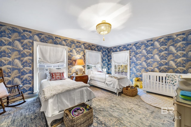 bedroom featuring ornamental molding and wallpapered walls