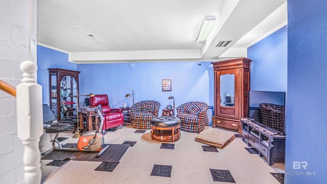 game room with tile patterned floors and crown molding