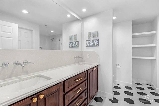 bathroom with vanity and a shower with door