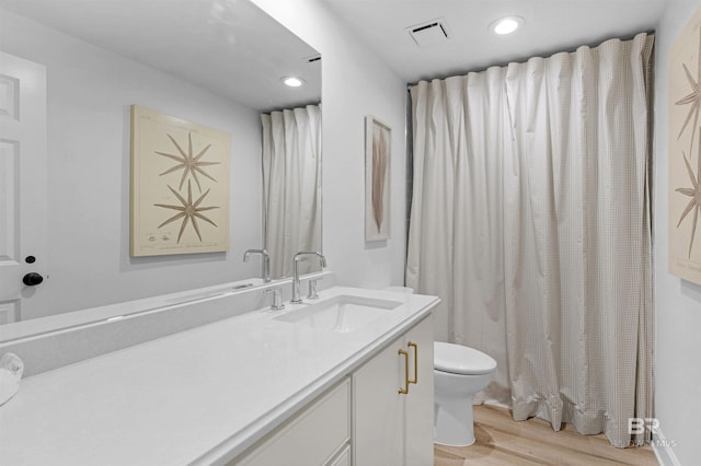 bathroom featuring hardwood / wood-style flooring, vanity, and toilet