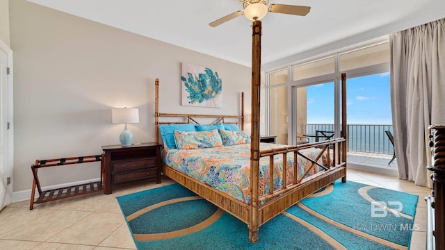 tiled bedroom featuring ceiling fan, access to outside, and baseboards