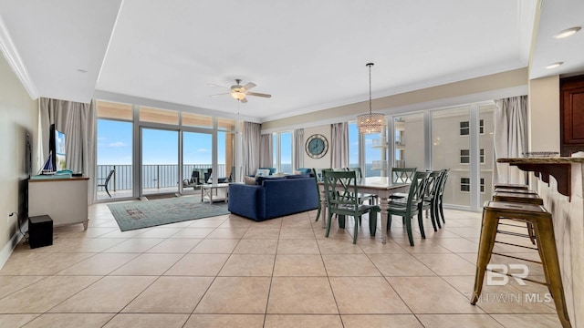 dining room with light tile patterned floors, ceiling fan, a wealth of natural light, and crown molding