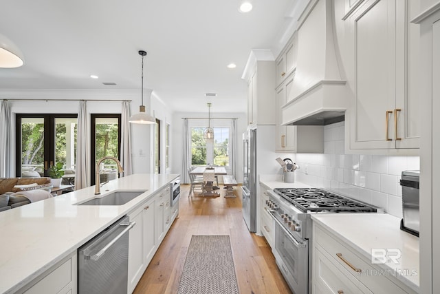 313 Cuban Lily Dr, Fairhope, AL 36532 - kitchen featuring premium range hood, a sink, high end appliances, light countertops, and pendant lighting