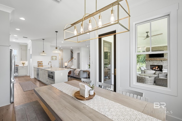 313 Cuban Lily Dr, Fairhope, AL 36532 - dining area with wood finished floors, plenty of natural light, ceiling fan, stairs, and recessed lighting