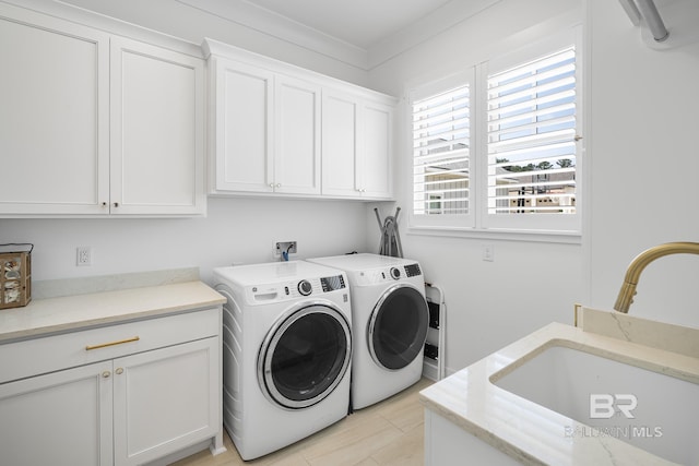 313 Cuban Lily Dr, Fairhope, AL 36532 - laundry room featuring cabinet space and washing machine and clothes dryer