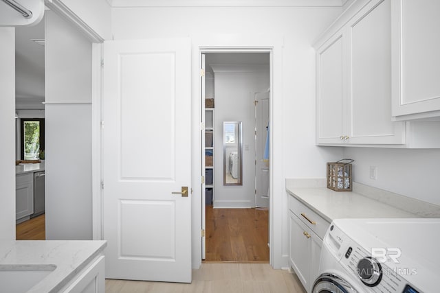 313 Cuban Lily Dr, Fairhope, AL 36532 - laundry area with cabinet space, independent washer and dryer, and light wood-style floors