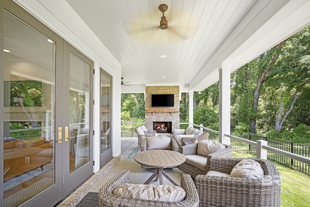 313 Cuban Lily Dr, Fairhope, AL 36532 - wooden terrace featuring an outdoor living space with a fireplace, french doors, and a patio area
