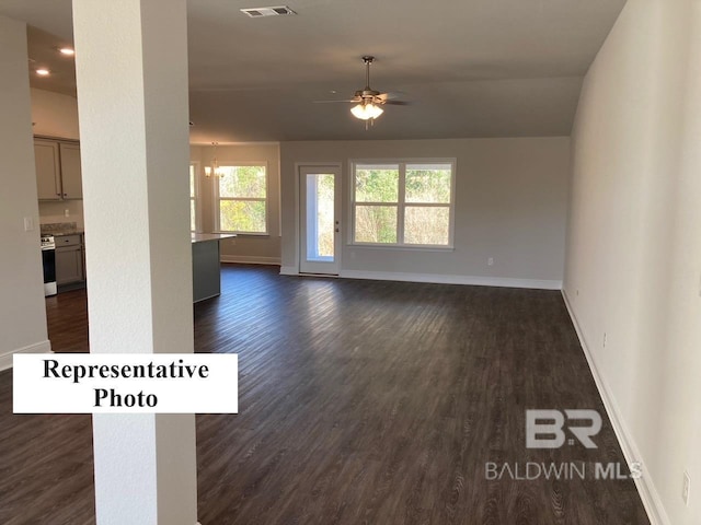 unfurnished living room with ceiling fan and dark hardwood / wood-style flooring