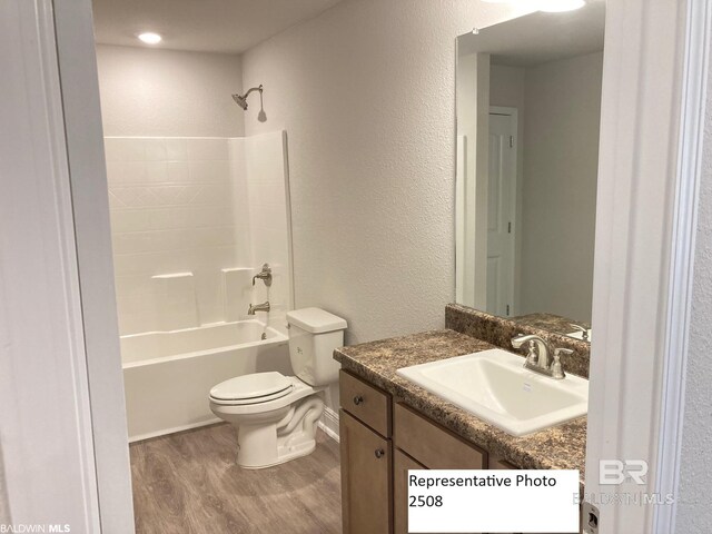 full bathroom featuring toilet, vanity, shower / washtub combination, and wood-type flooring