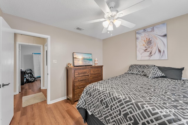 108 Paige Cir, Daphne, AL 36526 - bedroom featuring wood finished floors, a ceiling fan, baseboards, and a textured ceiling