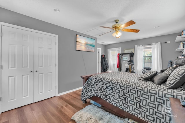 108 Paige Cir, Daphne, AL 36526 - bedroom with a closet, wood finished floors, ceiling fan, baseboards, and a textured ceiling