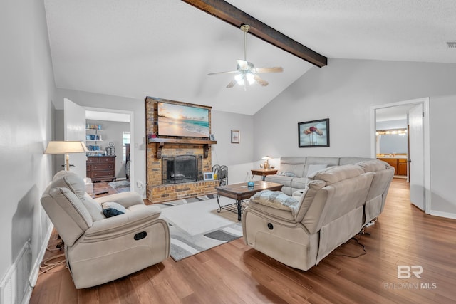 108 Paige Cir, Daphne, AL 36526 - living area featuring a brick fireplace, wood finished floors, a ceiling fan, and baseboards