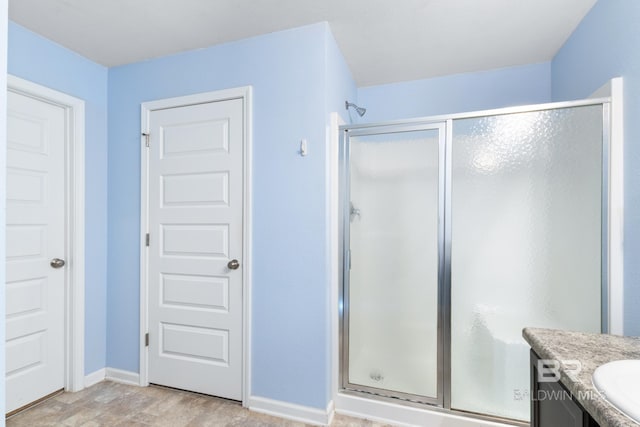 bathroom featuring vanity and an enclosed shower