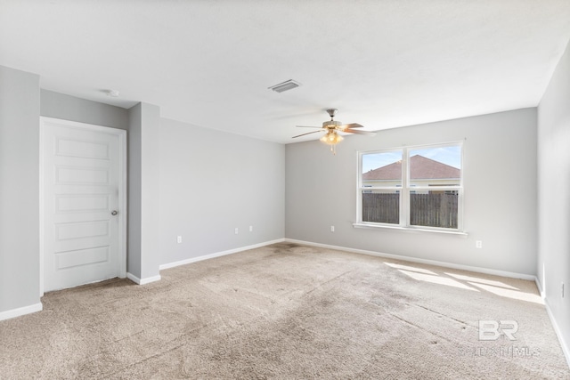 carpeted spare room with ceiling fan