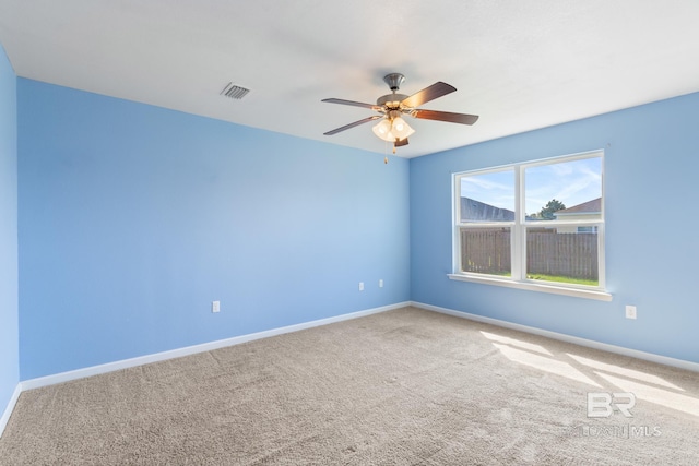 unfurnished room with ceiling fan and carpet flooring