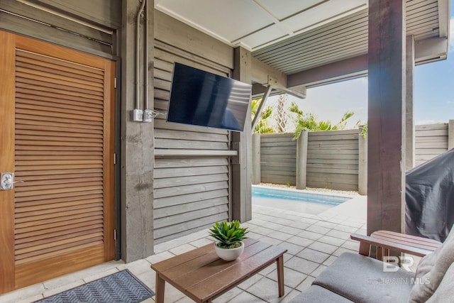 view of patio / terrace featuring a fenced in pool and fence
