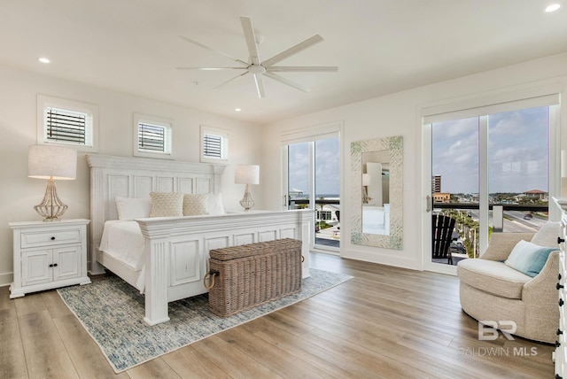 bedroom featuring access to exterior, recessed lighting, baseboards, and light wood finished floors