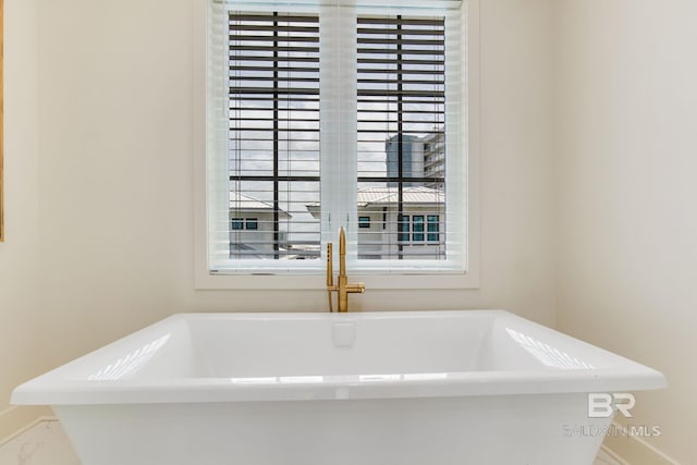 bathroom with a freestanding tub