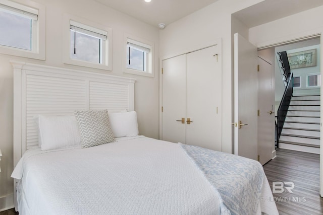 bedroom with recessed lighting, a closet, and wood finished floors