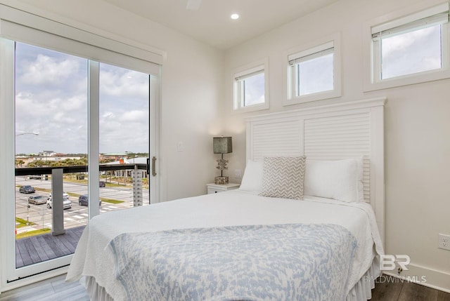 bedroom with recessed lighting, baseboards, wood finished floors, and access to exterior