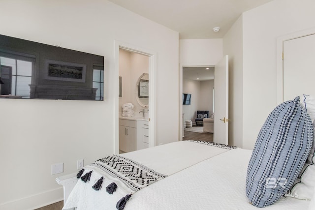 bedroom featuring connected bathroom and a sink