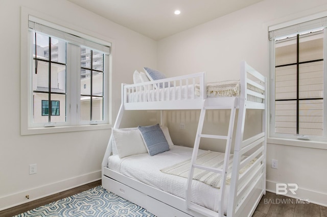 bedroom with recessed lighting, wood finished floors, and baseboards