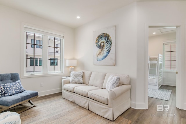 living area featuring recessed lighting, baseboards, attic access, and wood finished floors
