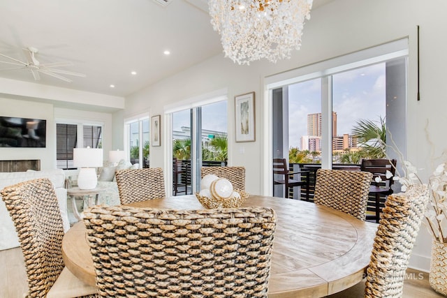 dining area featuring recessed lighting and ceiling fan with notable chandelier