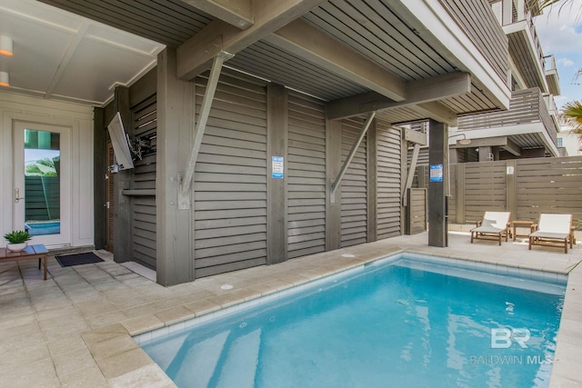 view of swimming pool featuring a fenced in pool, a patio, and fence