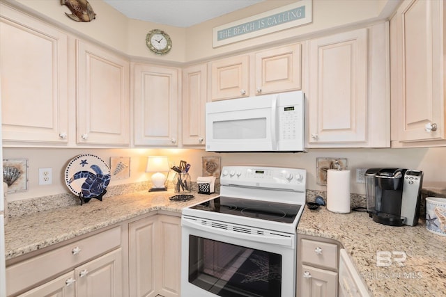 kitchen with light stone countertops and white appliances