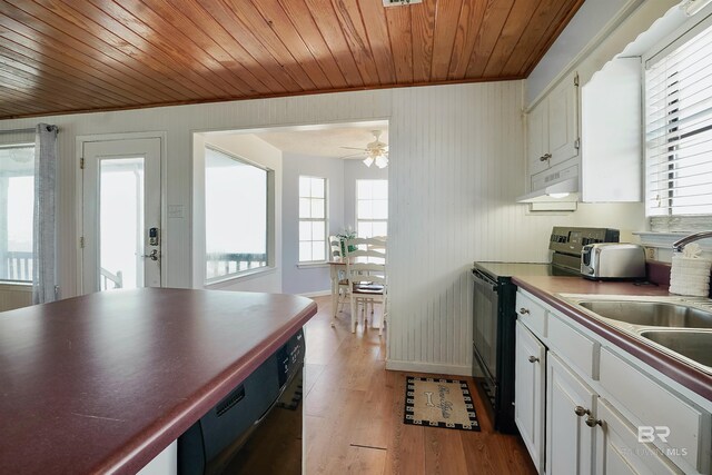 747 Cherokee Rd, Gulf Shores, AL 36542 - kitchen featuring light wood-style flooring, white cabinetry, under cabinet range hood, and black appliances