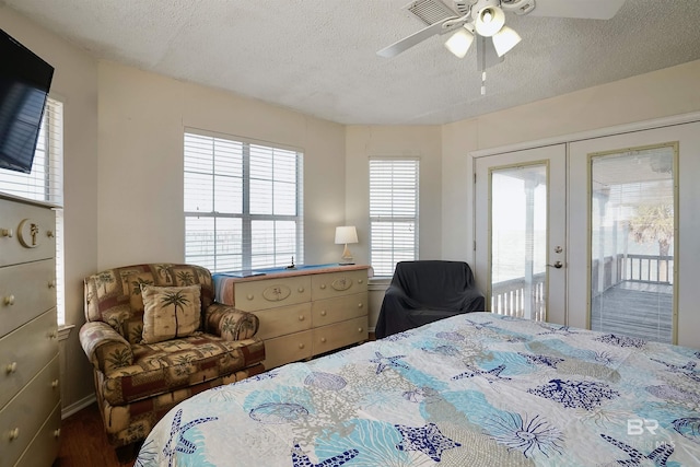 747 Cherokee Rd, Gulf Shores, AL 36542 - bedroom with access to exterior, french doors, dark wood-type flooring, a ceiling fan, and a textured ceiling