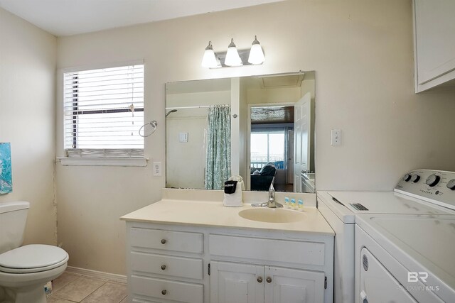 747 Cherokee Rd, Gulf Shores, AL 36542 - ensuite bathroom featuring toilet, ensuite bathroom, tile patterned flooring, vanity, and separate washer and dryer