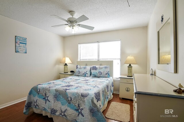 747 Cherokee Rd, Gulf Shores, AL 36542 - bedroom featuring dark wood-style floors, a textured ceiling, and baseboards