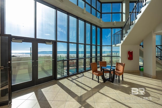 24230 Perdido Beach Blvd Unit 3112, Orange Beach, AL 36561 - sunroom / solarium featuring a healthy amount of sunlight, a towering ceiling, floor to ceiling windows, and tile patterned flooring
