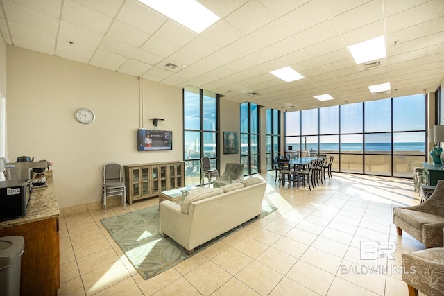 24230 Perdido Beach Blvd Unit 3112, Orange Beach, AL 36561 - living room featuring a wall of windows, light tile patterned floors, a paneled ceiling, and visible vents