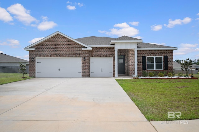 view of front of property with a front lawn, an attached garage, and brick siding