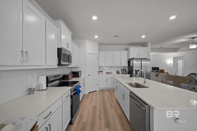 kitchen featuring white cabinets, recessed lighting, appliances with stainless steel finishes, and a sink