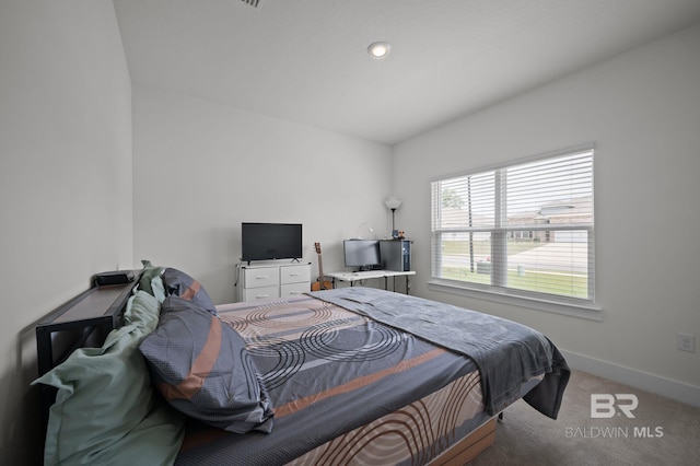 carpeted bedroom featuring baseboards