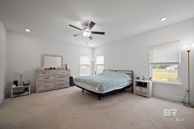 carpeted bedroom with baseboards, recessed lighting, and multiple windows