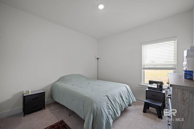 carpeted bedroom featuring baseboards