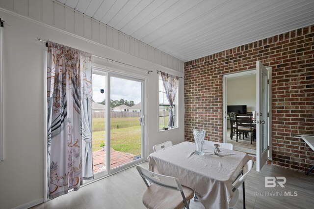 sunroom featuring outdoor dining space