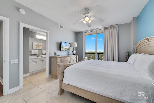 13597 Perdido Key Dr Unit E-5A, Pensacola, FL 32507 - bedroom featuring access to exterior, ensuite bathroom, light tile patterned floors, ceiling fan, and baseboards