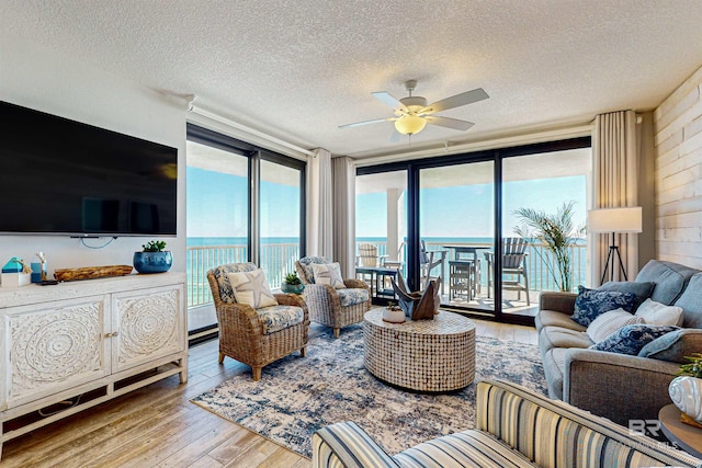 25020 Perdido Beach Blvd Unit 1101B, Orange Beach, AL 36561 - living area featuring hardwood / wood-style floors, a textured ceiling, and ceiling fan