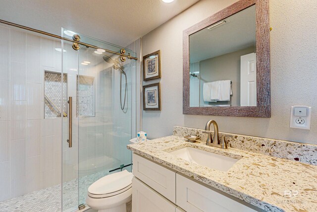 25020 Perdido Beach Blvd Unit 1101B, Orange Beach, AL 36561 - full bath featuring a stall shower, toilet, vanity, and a textured wall