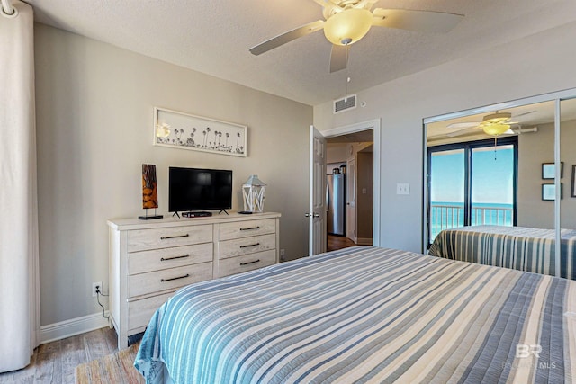 25020 Perdido Beach Blvd Unit 1101B, Orange Beach, AL 36561 - bedroom featuring access to exterior, light wood-style flooring, freestanding refrigerator, baseboards, and ceiling fan