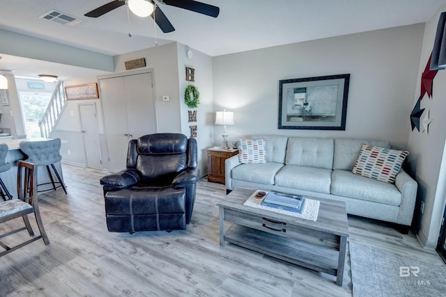 112 W 8th Ave Unit 7, Gulf Shores, AL 36542 - living area featuring light wood-style floors, ceiling fan, and baseboards