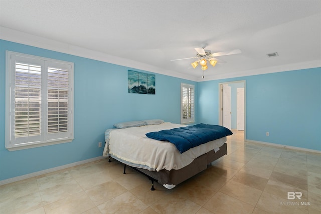 tiled bedroom with ceiling fan, crown molding, and a textured ceiling