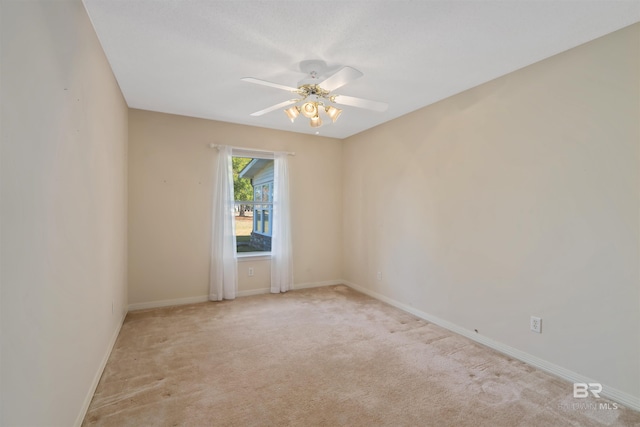 unfurnished room with ceiling fan and light carpet